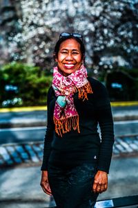 Portrait of a smiling young woman standing outdoors