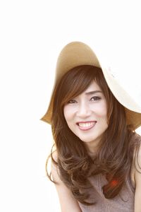 Portrait of young woman against white background