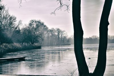 Scenic view of lake against sky during winter