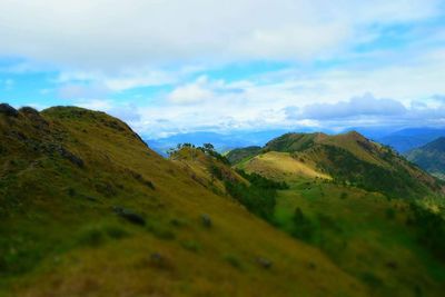 Scenic view of mountain against cloudy sky