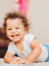 Portrait of cute mixed race or biracial baby boy with curly hair smiling 