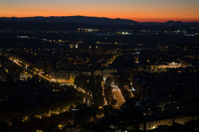 High angle view of illuminated buildings in city at night