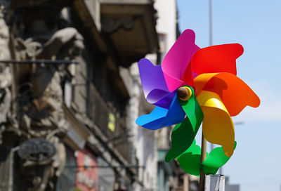 Close-up of multi colored pinwheel against old building