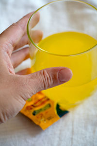 Woman holding a glass with the dissolved vitamins