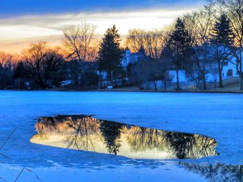 Scenic view of frozen lake against sky during winter