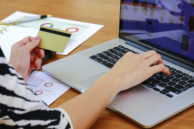 High angle view of woman using laptop on table