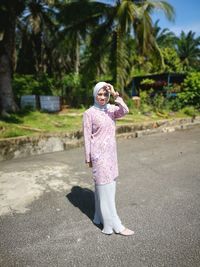 Portrait of woman standing on road