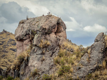 Low angle view of rock formation against sky