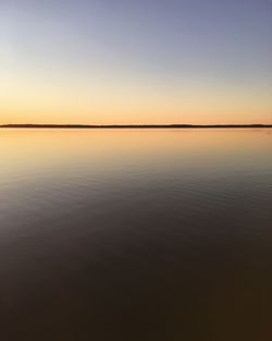 Scenic view of calm sea at sunset