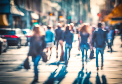 Blurred people walking in the city streets at the rush hour. time lapse motion effect. sunlight