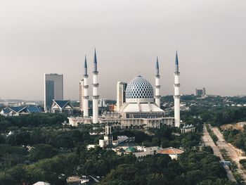 Buildings in city against sky