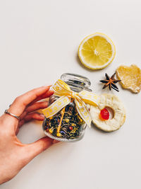 Cropped hand of person holding food on table