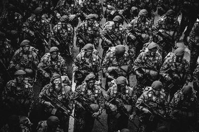 High angle view of army soldiers holding weapon at parade