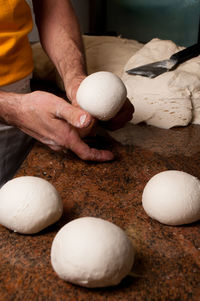 Close-up of man preparing food on table