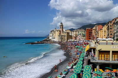 Buildings at sea shore against sky in camogli