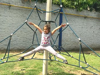 Portrait of girl on swing at playground