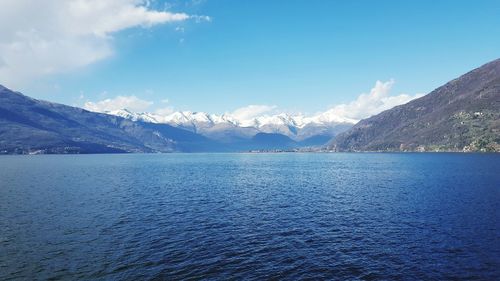 Scenic view of sea and mountains against sky