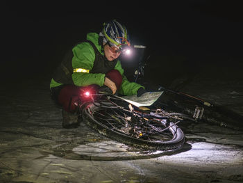 Woman biker travel in extreme night snowy nature. sport and healthy life. extreme sports.