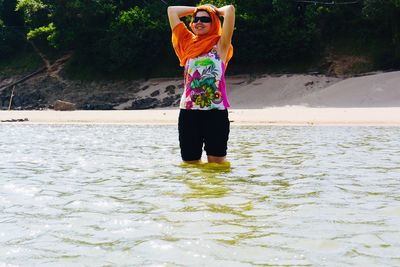 Full length of woman standing in water