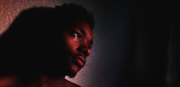 Close-up portrait of young woman looking away