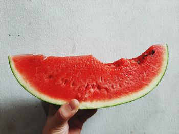 Close-up of hand holding strawberry