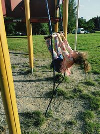 Low angle view of girl playing on slide at playground