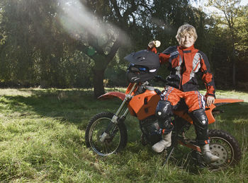 12 year old boy having a break on his off road motorbike