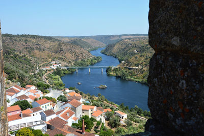 High angle view of townscape by mountain against clear sky