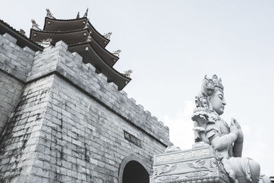 Low angle view of statue against building