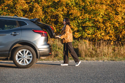 Rear view of man walking on road