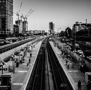 High angle view of people at railroad station platform amidst buildings in city