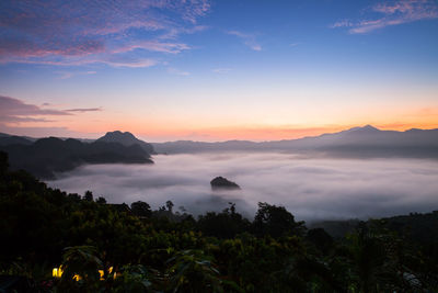 Scenic view of silhouette mountains against sky during sunset