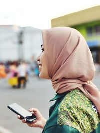 Rear view of woman using mobile phone