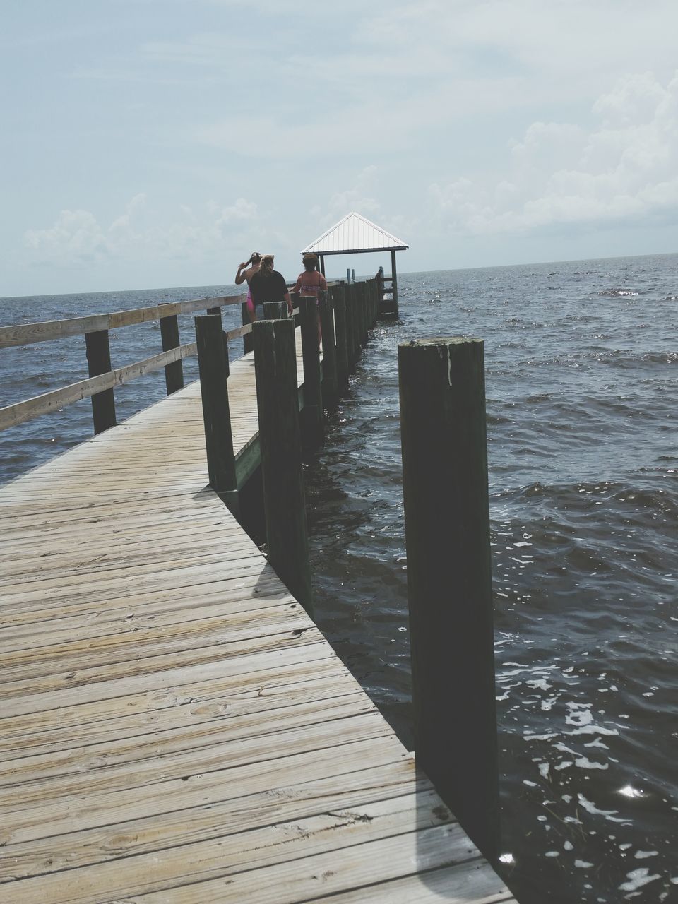 water, sea, pier, horizon over water, sky, tranquil scene, tranquility, scenics, wood - material, men, nature, leisure activity, beach, railing, beauty in nature, jetty, lifestyles, person