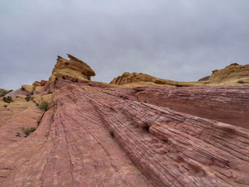 Low angle landscape of pink and yellow slanted stone hill at valley of fire state park in nevada