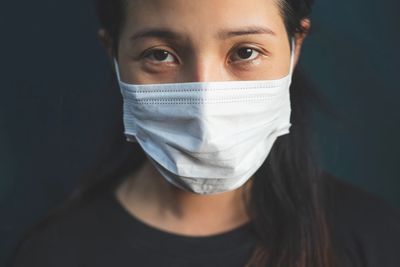 Close-up portrait of woman covering face