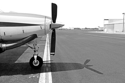 Airplane on runway against clear sky