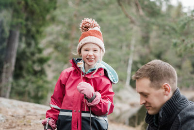 Young girl smiling whist eating a marshmallow whilst camping in sweden