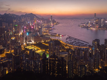 High angle view of illuminated buildings against sky at night