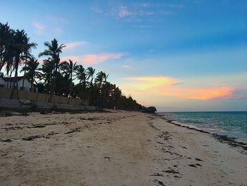 Scenic view of beach against sky during sunset