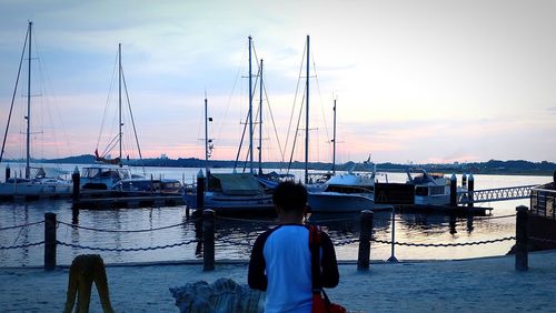 Boats in harbor at sunset