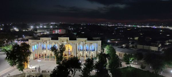 High angle view of illuminated street and buildings at night