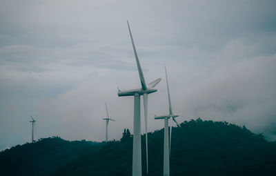 Low angle view of windmill against sky