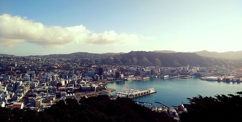 Panoramic view of sea and cityscape against sky