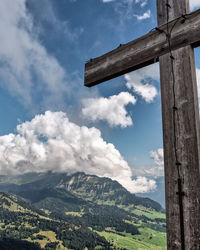 Scenic view of mountains against sky with cross