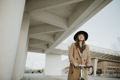 Young hipster woman with a bicycle