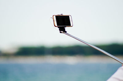 Close-up of mobile phone on selfie stick