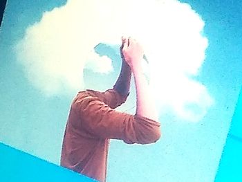 Man standing by swimming pool against wall