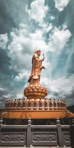 Low angle view of statue against sky