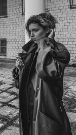 Young woman standing on street in city